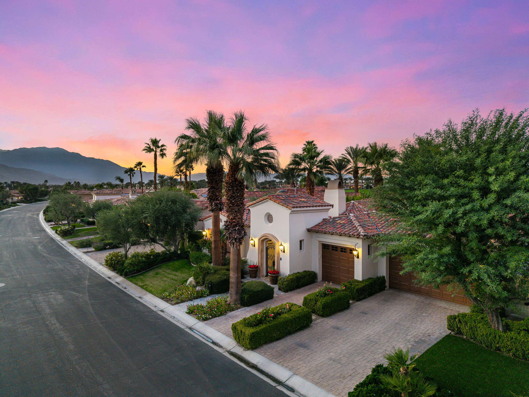75836 Via Cortona Indian Wells, CA 92210 - Photo 77 of 113 a front view of a house with a yard and garage