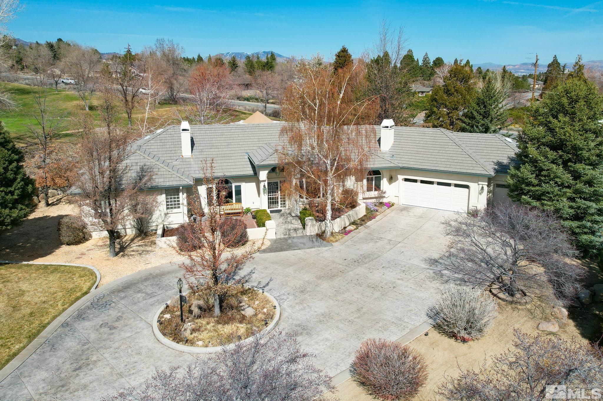 an aerial view of a house with a yard swimming pool and outdoor seating