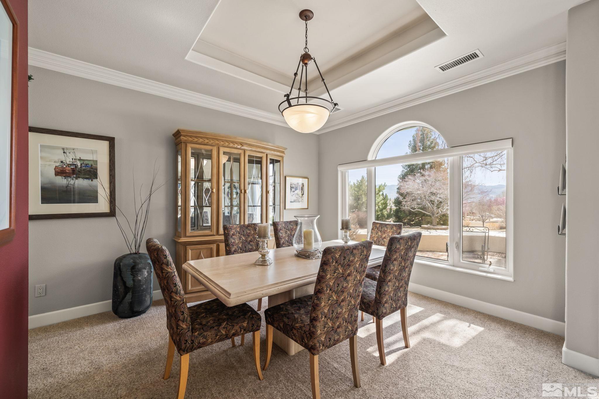 1335 Wolf Run Road Reno, NV 89511 - Photo 18 of 37 a dining room with wooden floor a chandelier a wooden table and chairs
