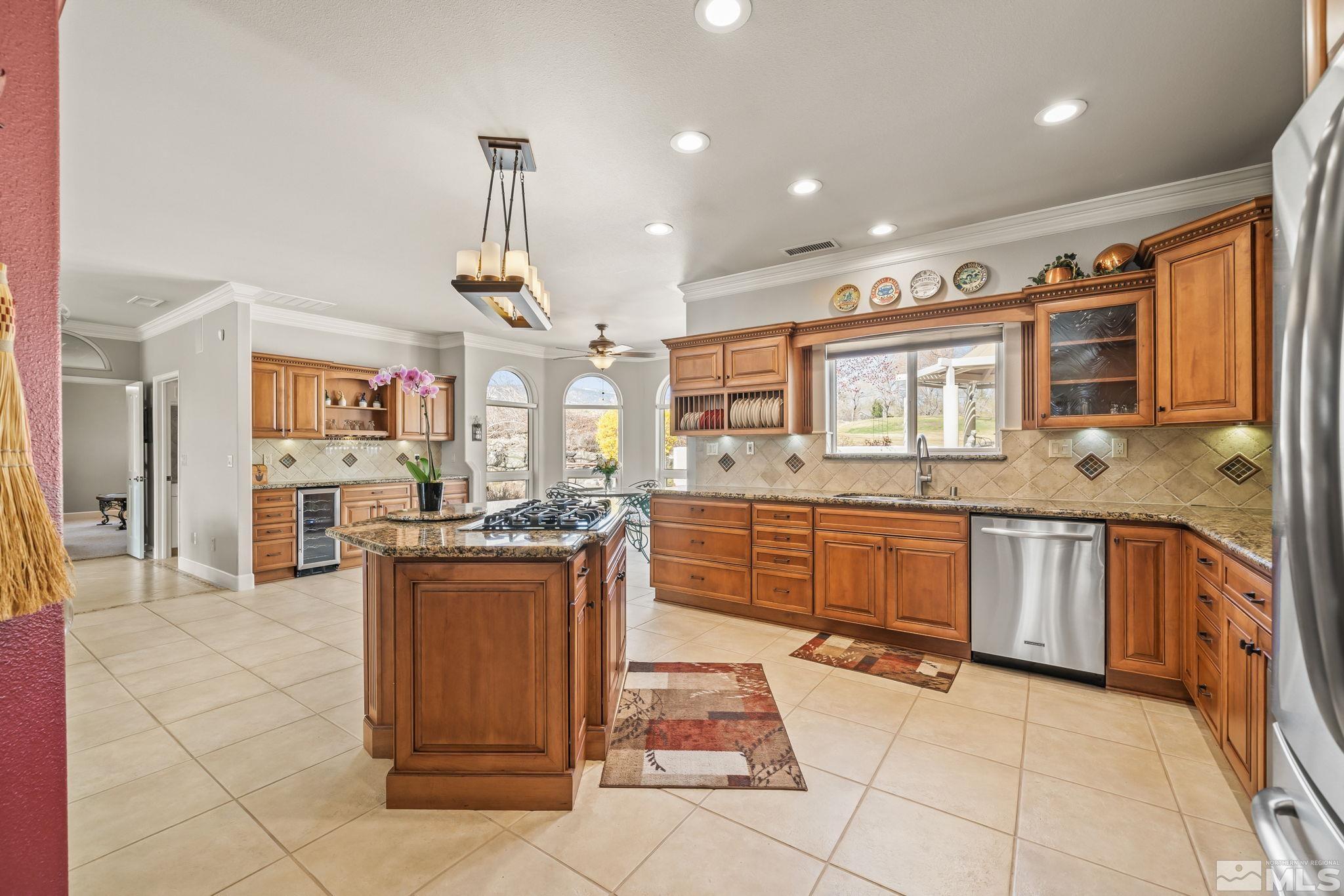 1335 Wolf Run Road Reno, NV 89511 - Photo 19 of 37 a kitchen with stainless steel appliances granite countertop a stove and cabinets