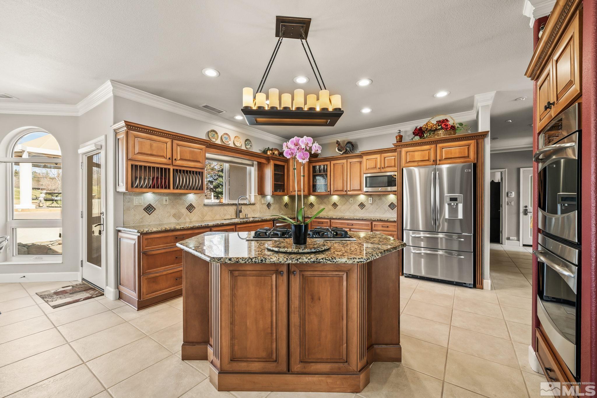 1335 Wolf Run Road Reno, NV 89511 - Photo 20 of 37 a kitchen with stainless steel appliances granite countertop a stove and a refrigerator