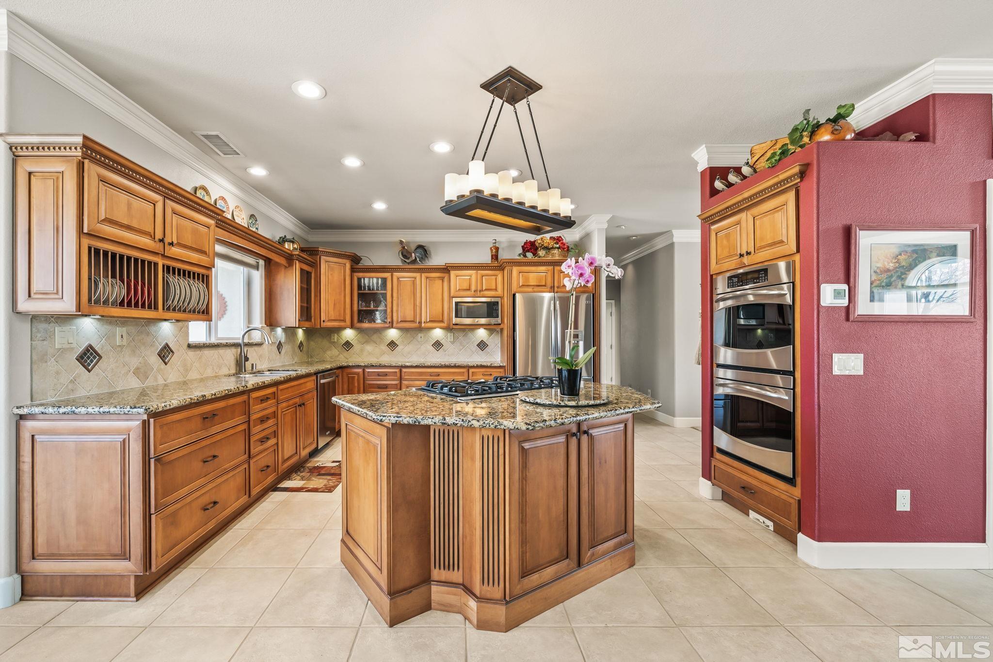 1335 Wolf Run Road Reno, NV 89511 - Photo 21 of 37 a kitchen with stainless steel appliances granite countertop a stove and a sink