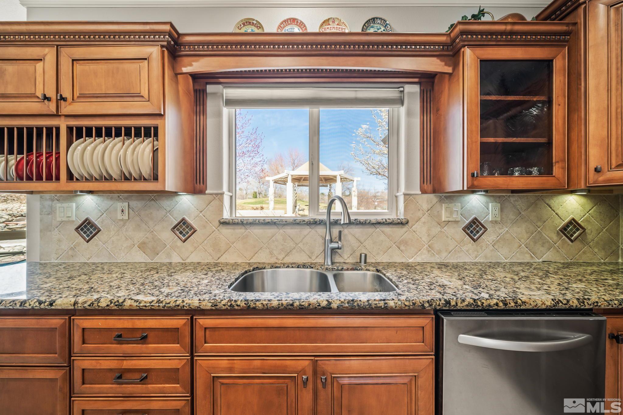 1335 Wolf Run Road Reno, NV 89511 - Photo 23 of 37 a kitchen with granite countertop a sink and a stove