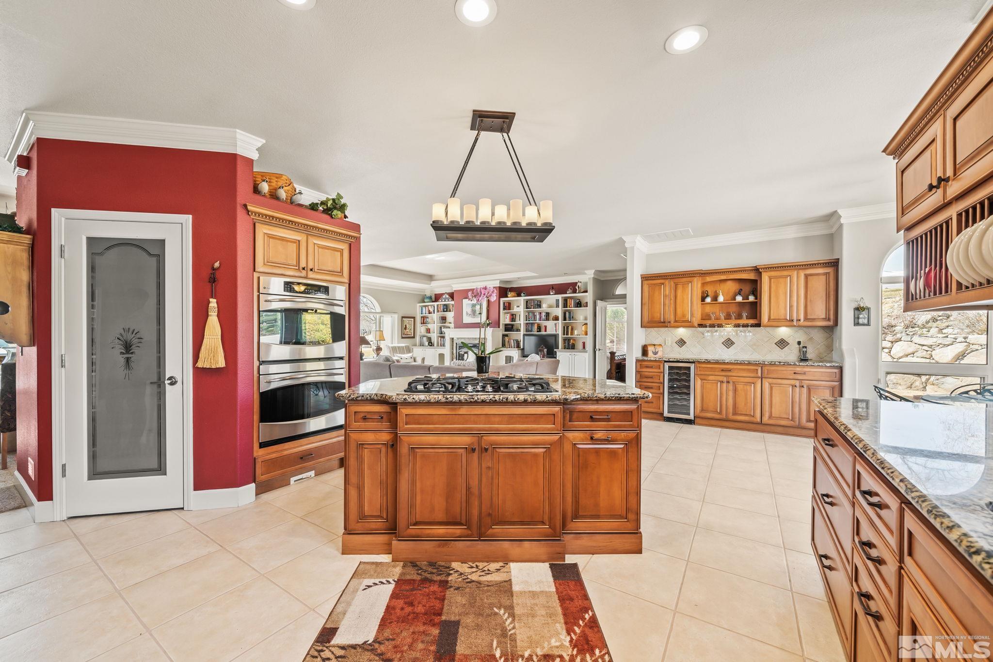 1335 Wolf Run Road Reno, NV 89511 - Photo 24 of 37 a kitchen with stainless steel appliances granite countertop a stove and cabinets