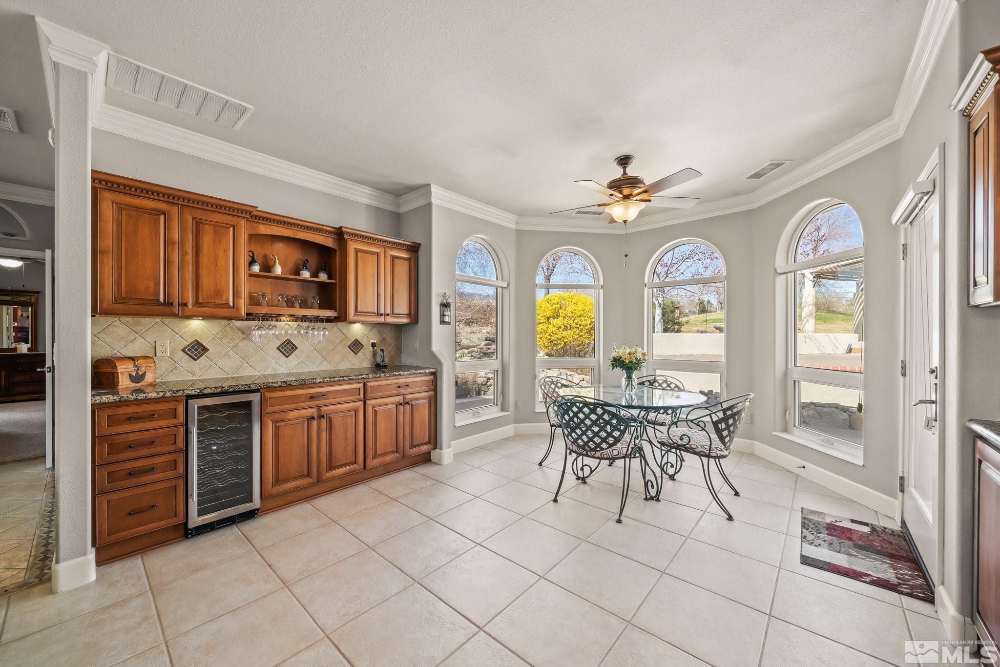 1335 Wolf Run Road Reno, NV 89511 - Photo 25 of 37 a kitchen with stainless steel appliances granite countertop a stove top oven a sink a dining table and chairs with wooden floor