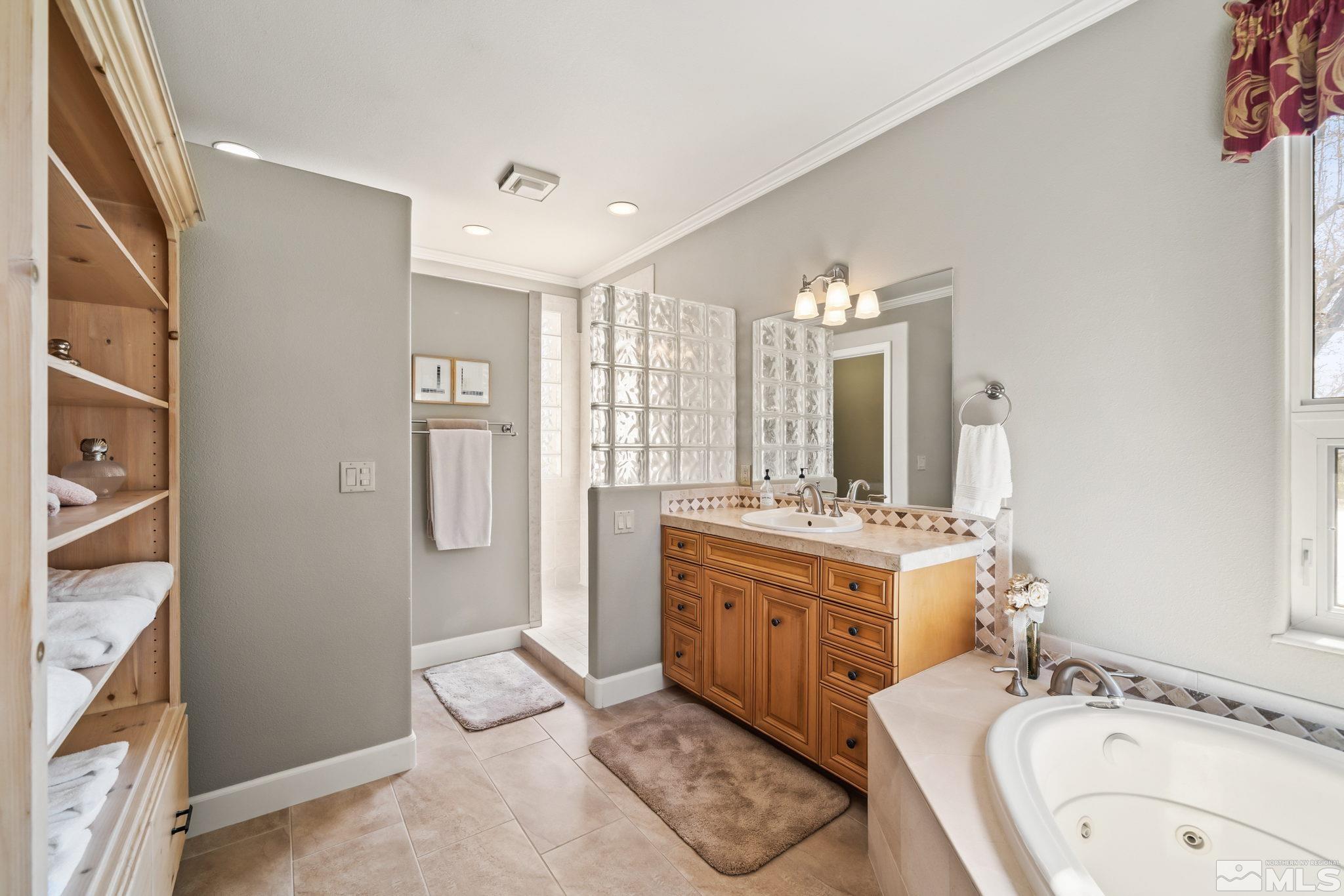 1335 Wolf Run Road Reno, NV 89511 - Photo 30 of 37 a spacious bathroom with a granite countertop sink a mirror and a bathtub