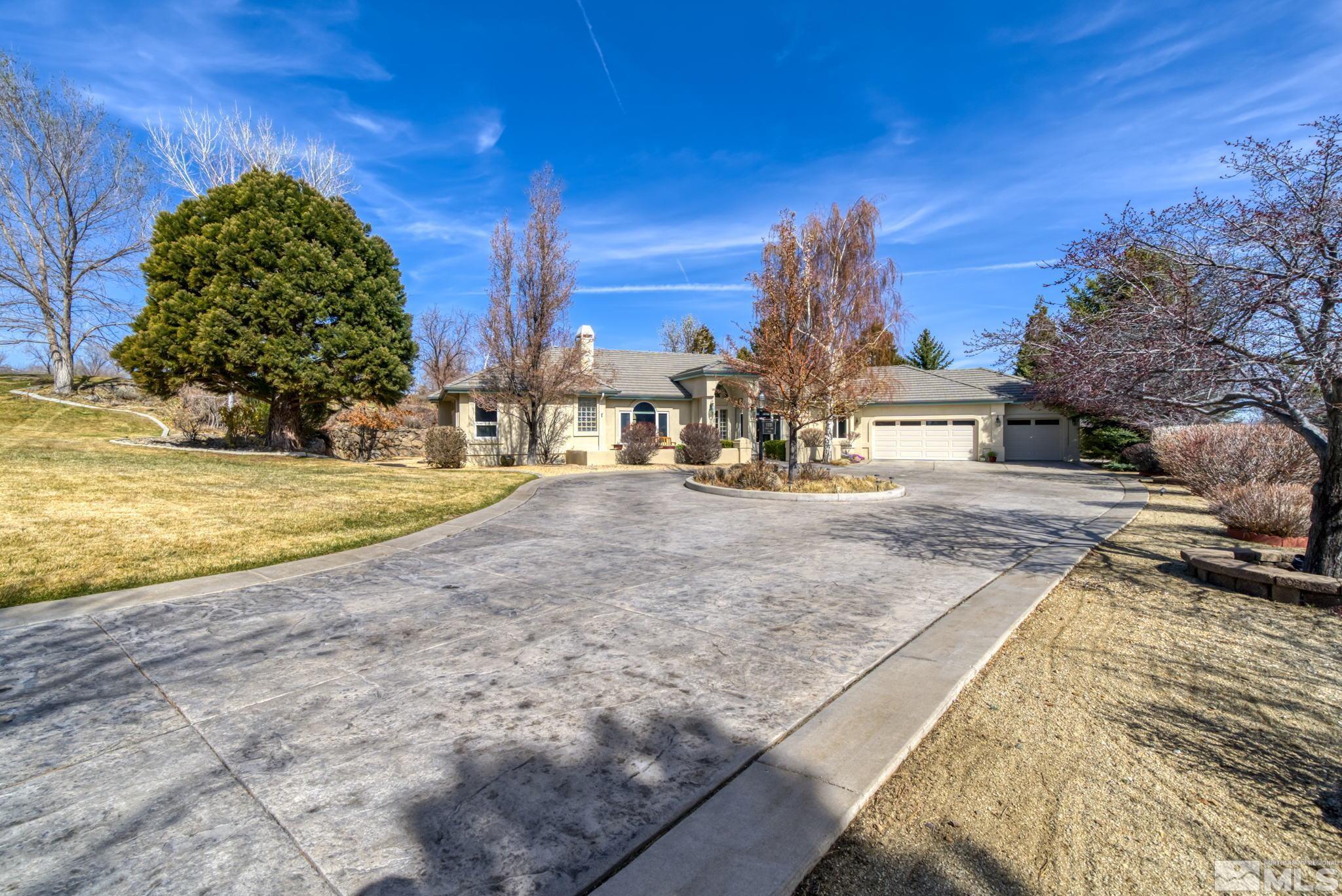 1335 Wolf Run Road Reno, NV 89511 - Photo 3 of 37 a view of a swimming pool with a house in the background