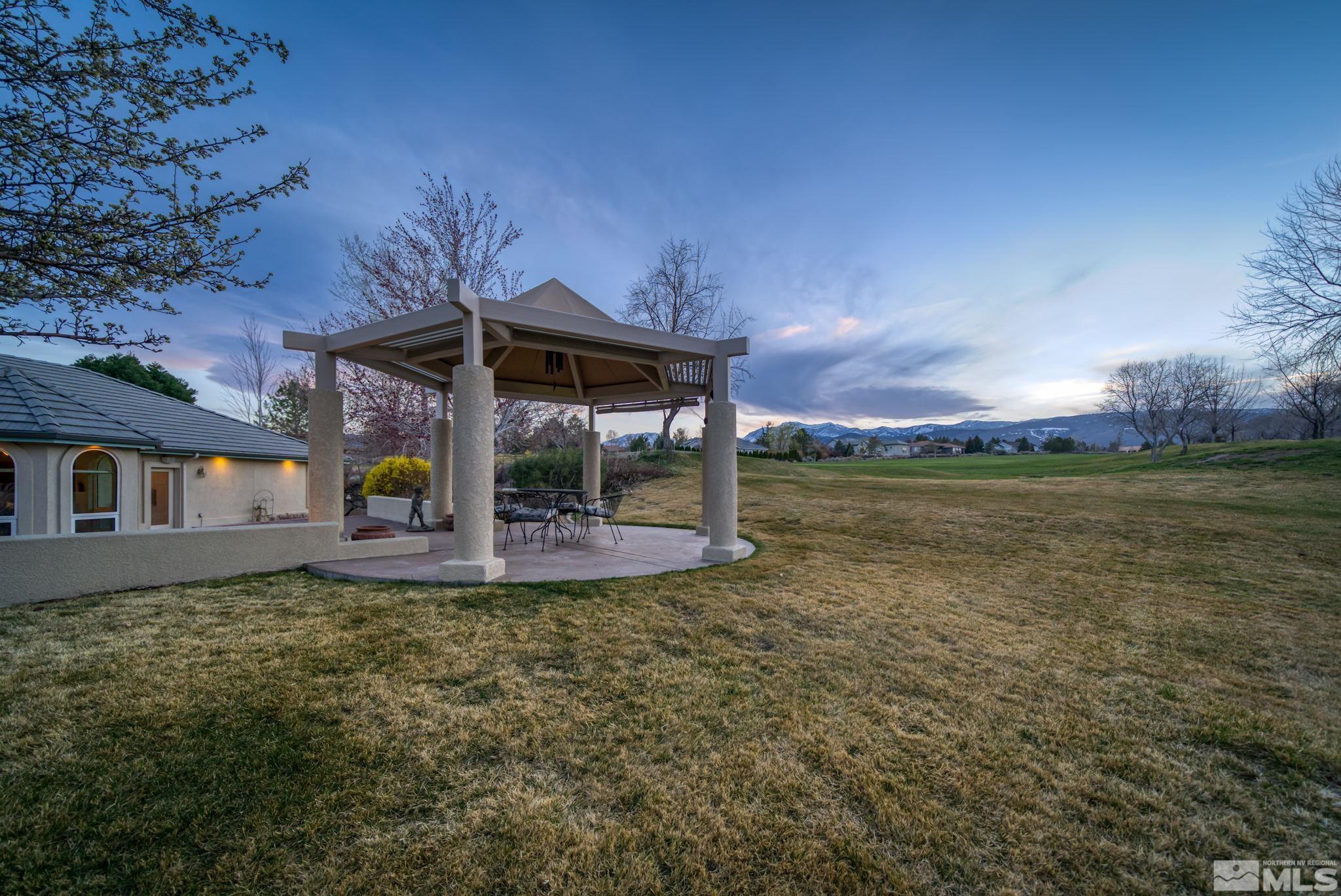 1335 Wolf Run Road Reno, NV 89511 - Photo 34 of 37 a view of a patio with table and chairs under an umbrella