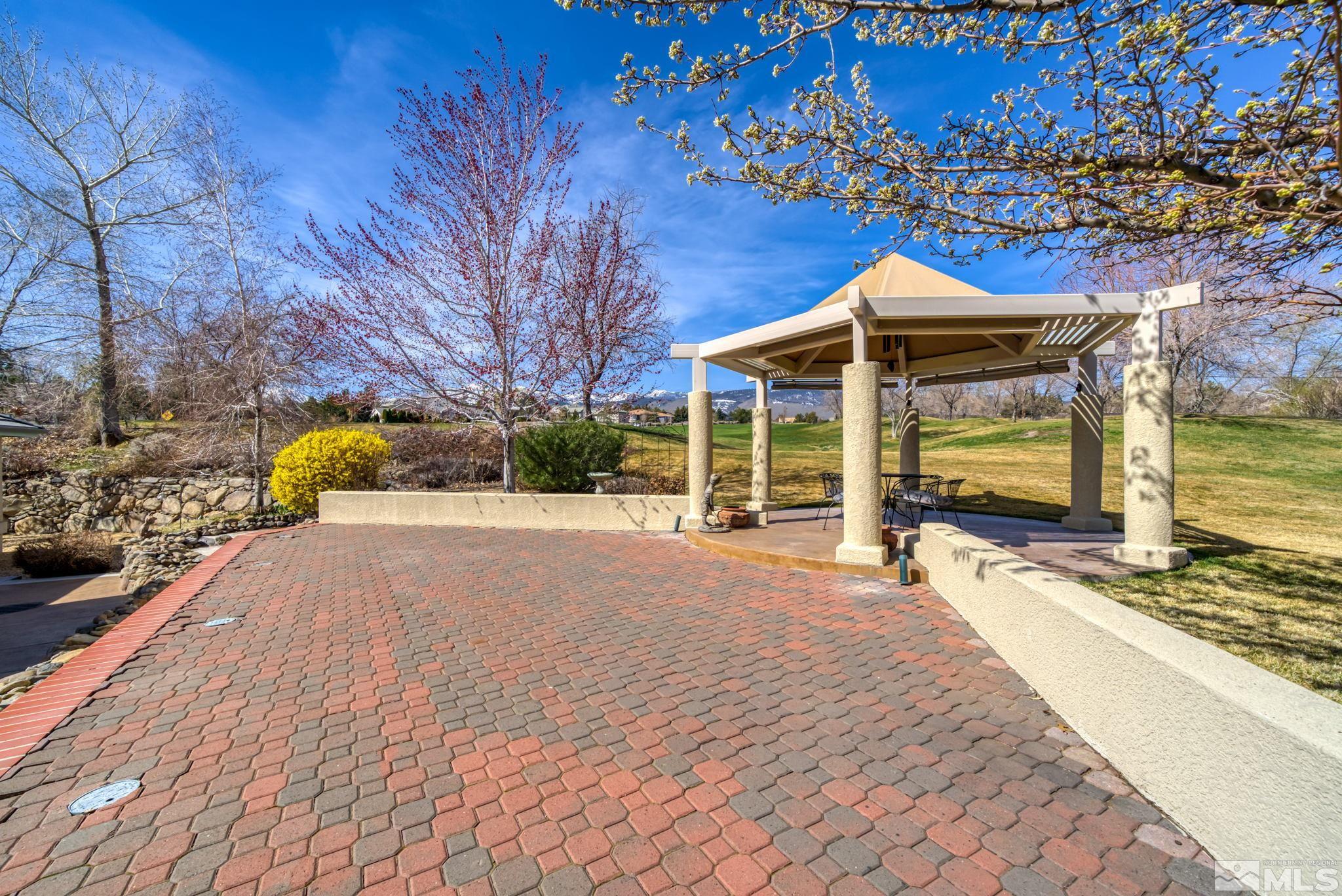 1335 Wolf Run Road Reno, NV 89511 - Photo 7 of 37 a front view of a house with a yard and garage