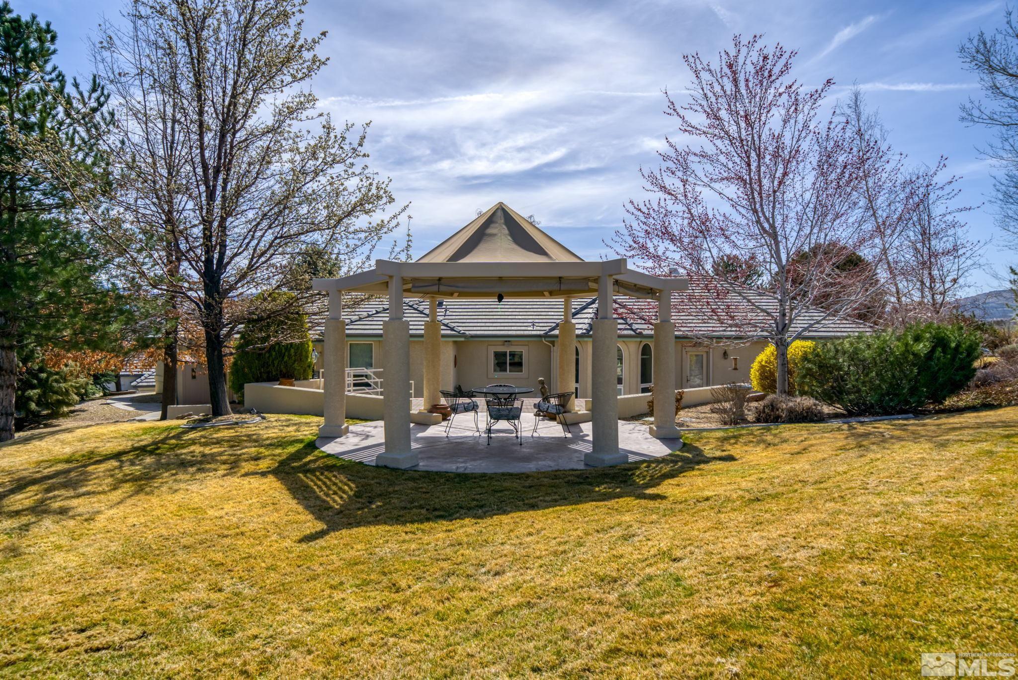 1335 Wolf Run Road Reno, NV 89511 - Photo 9 of 37 a view of a fountain with swimming pool in front of house