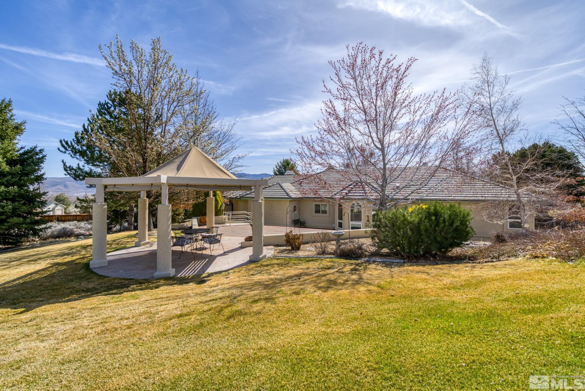 1335 Wolf Run Road Reno, NV 89511 - Photo 10 of 37 a view of a house with backyard patio and fire pit