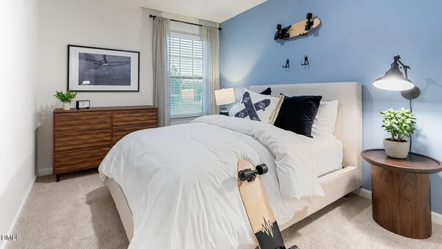 a bedroom with bed and a potted plant