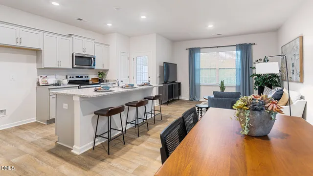 a large kitchen with a table and chairs in it
