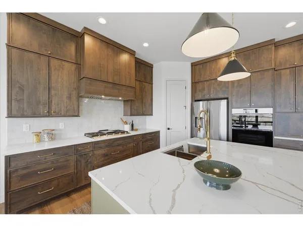 a kitchen with a sink appliances and cabinets