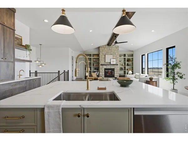 a kitchen with a sink a counter space appliances and cabinets
