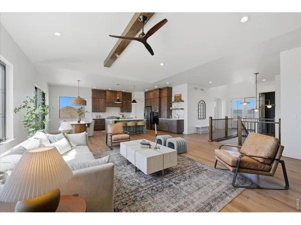 a living room with furniture and kitchen view