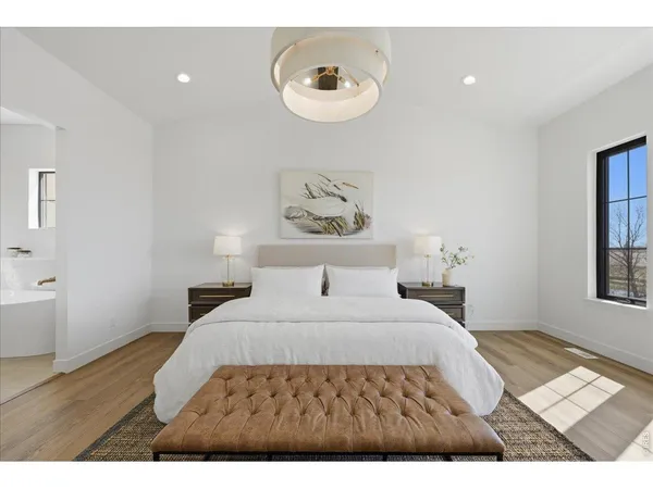 a bedroom with a bed and a painting on the wall