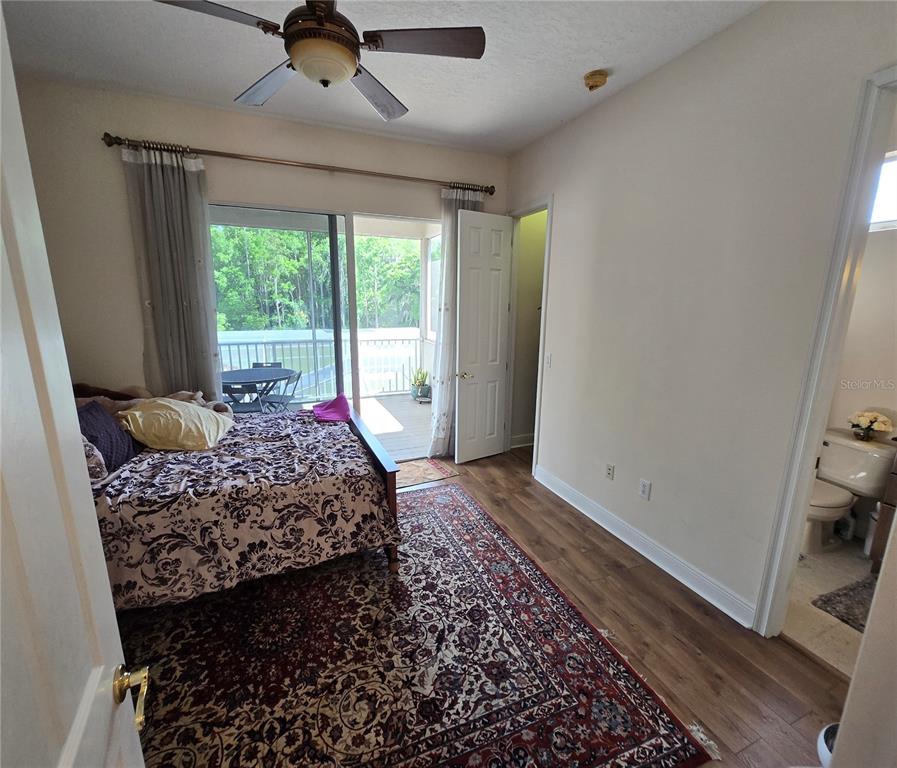 19153 Geraci Road Lutz, FL 33558 - Photo 11 of 21 a bed sitting in a bedroom next to a window
