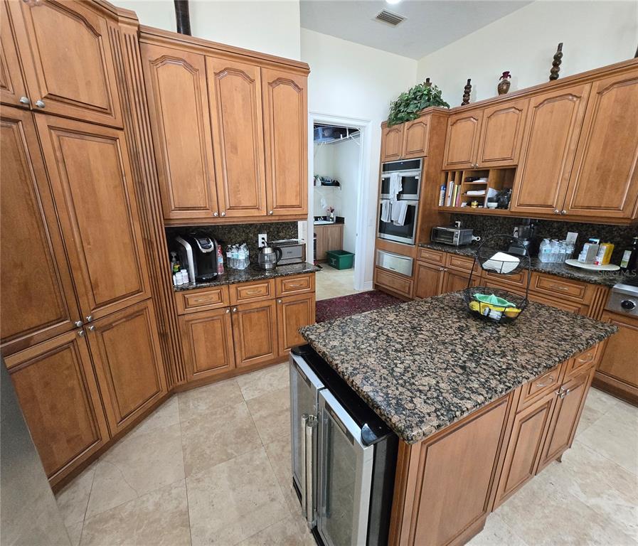 19153 Geraci Road Lutz, FL 33558 - Photo 18 of 21 a kitchen with stainless steel appliances granite countertop a sink stove and refrigerator