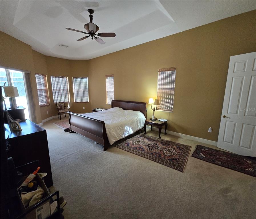 19153 Geraci Road Lutz, FL 33558 - Photo 7 of 21 a bedroom with two beds and a chandelier