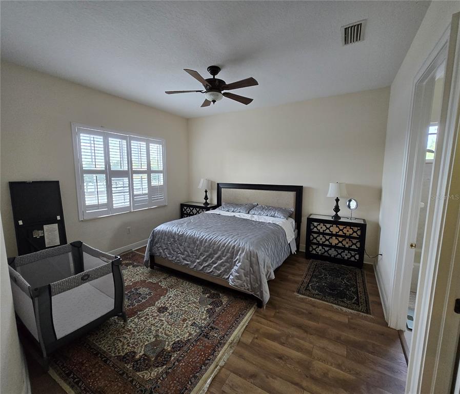 19153 Geraci Road Lutz, FL 33558 - Photo 10 of 21 a bedroom with a bed a couch and a window