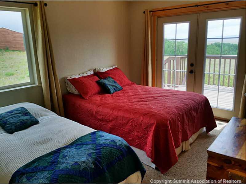 1469 Sheep Ridge Road Fairplay, CO 80440 - Photo 12 of 20 a bedroom with a bed and a window