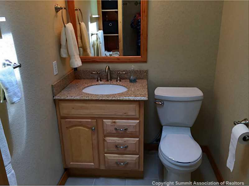 1469 Sheep Ridge Road Fairplay, CO 80440 - Photo 13 of 20 a bathroom with a granite countertop toilet sink and mirror