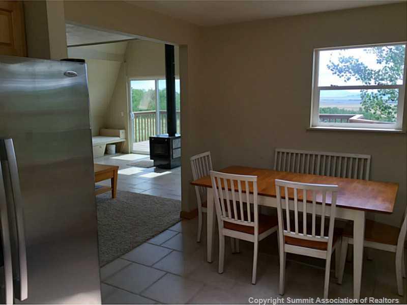 1469 Sheep Ridge Road Fairplay, CO 80440 - Photo 4 of 20 a view of a dining room with furniture wooden floor and a window