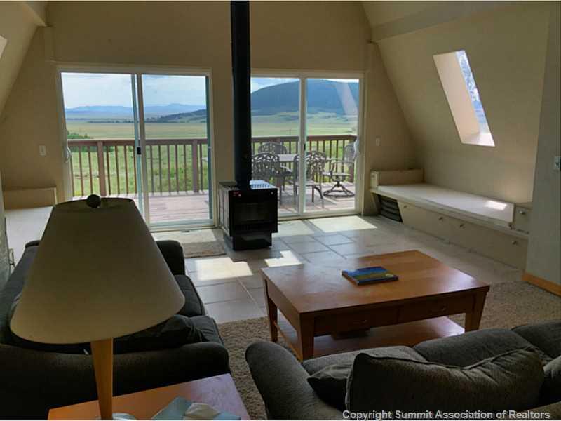 1469 Sheep Ridge Road Fairplay, CO 80440 - Photo 5 of 20 a living room with furniture and a floor to ceiling window