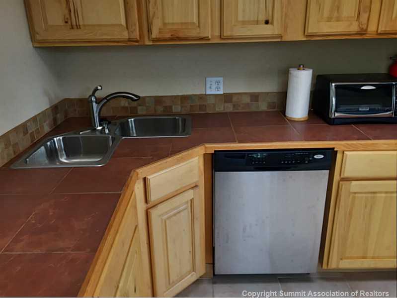1469 Sheep Ridge Road Fairplay, CO 80440 - Photo 9 of 20 a kitchen with granite countertop a sink and cabinets