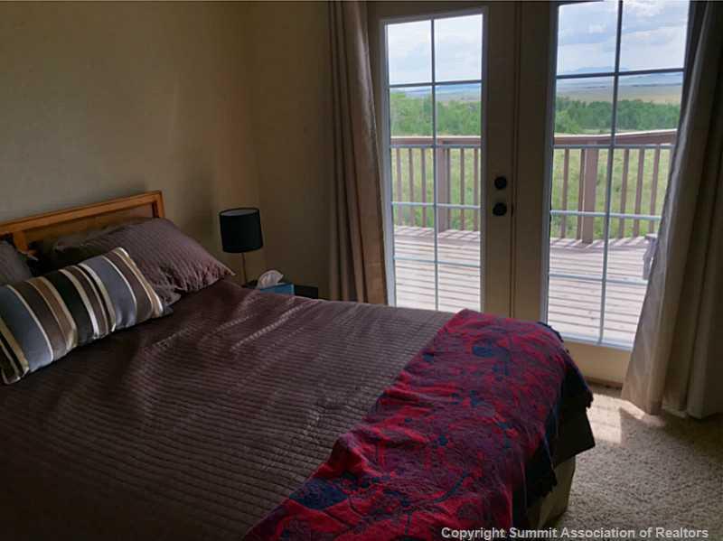 1469 Sheep Ridge Road Fairplay, CO 80440 - Photo 10 of 20 a bedroom with a bed and a window
