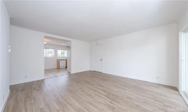 a kitchen with granite countertop white cabinets stainless steel appliances a sink and a window