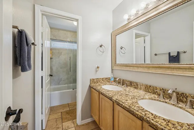 a bathroom with a bathtub sink and mirror