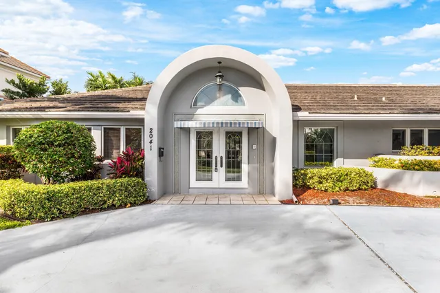 a view of a house in front of a house with a yard