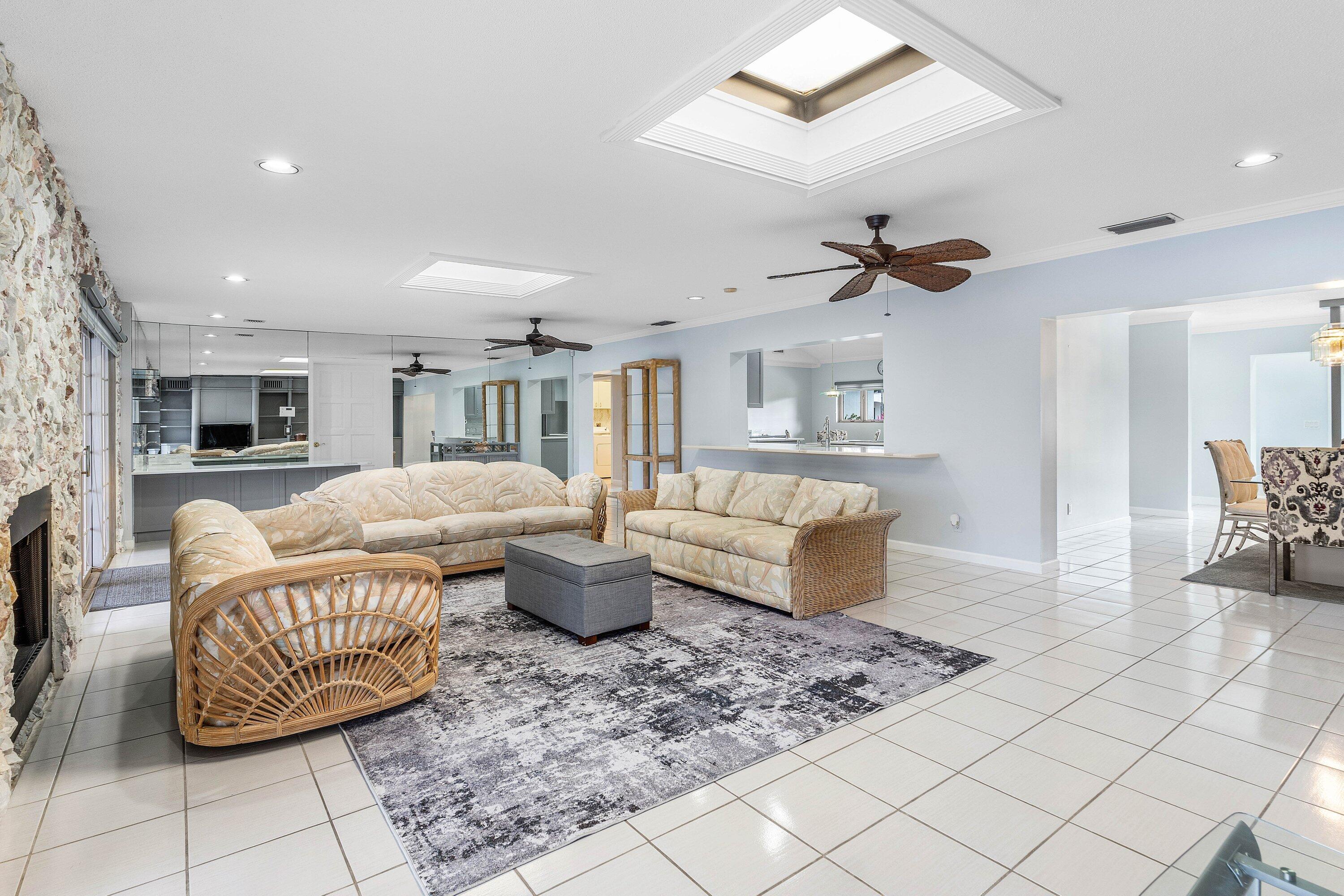 2041 Thatch Palm Drive Boca Raton, FL 33432 - Photo 22 of 45 a living room with furniture a rug and a chandelier