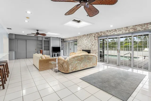 a large white kitchen with a sink and refrigerator
