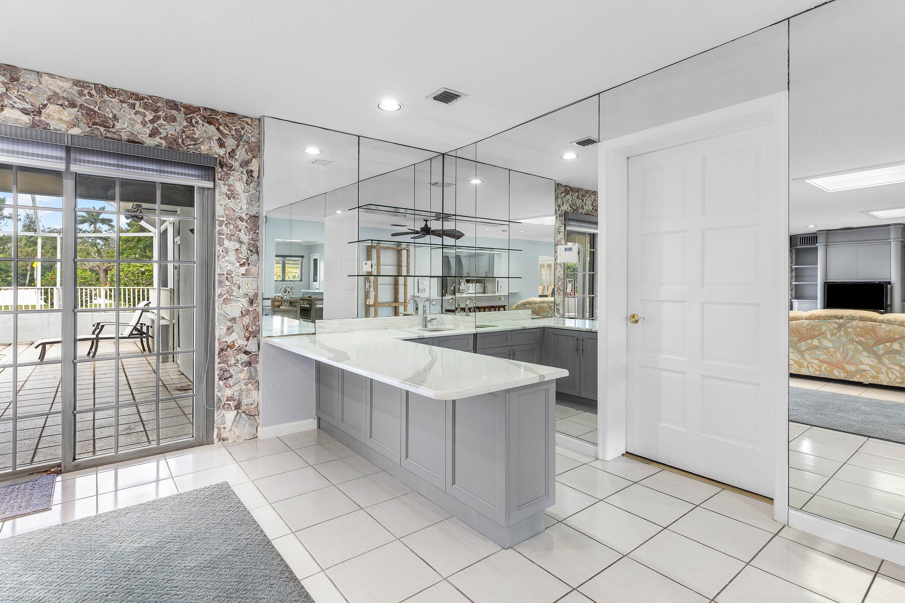 2041 Thatch Palm Drive Boca Raton, FL 33432 - Photo 24 of 45 a large white kitchen with a sink and refrigerator