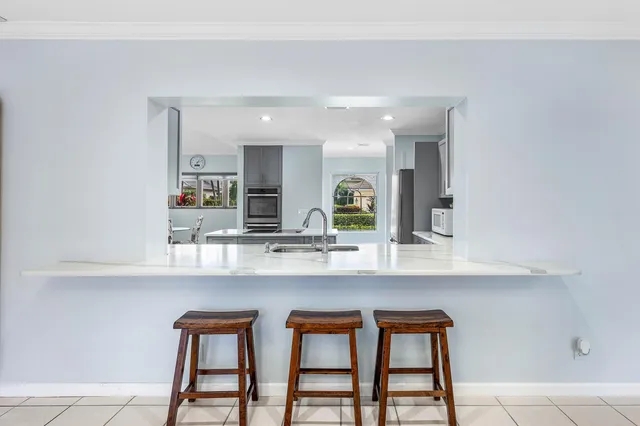 a kitchen with white cabinets a sink and white appliances