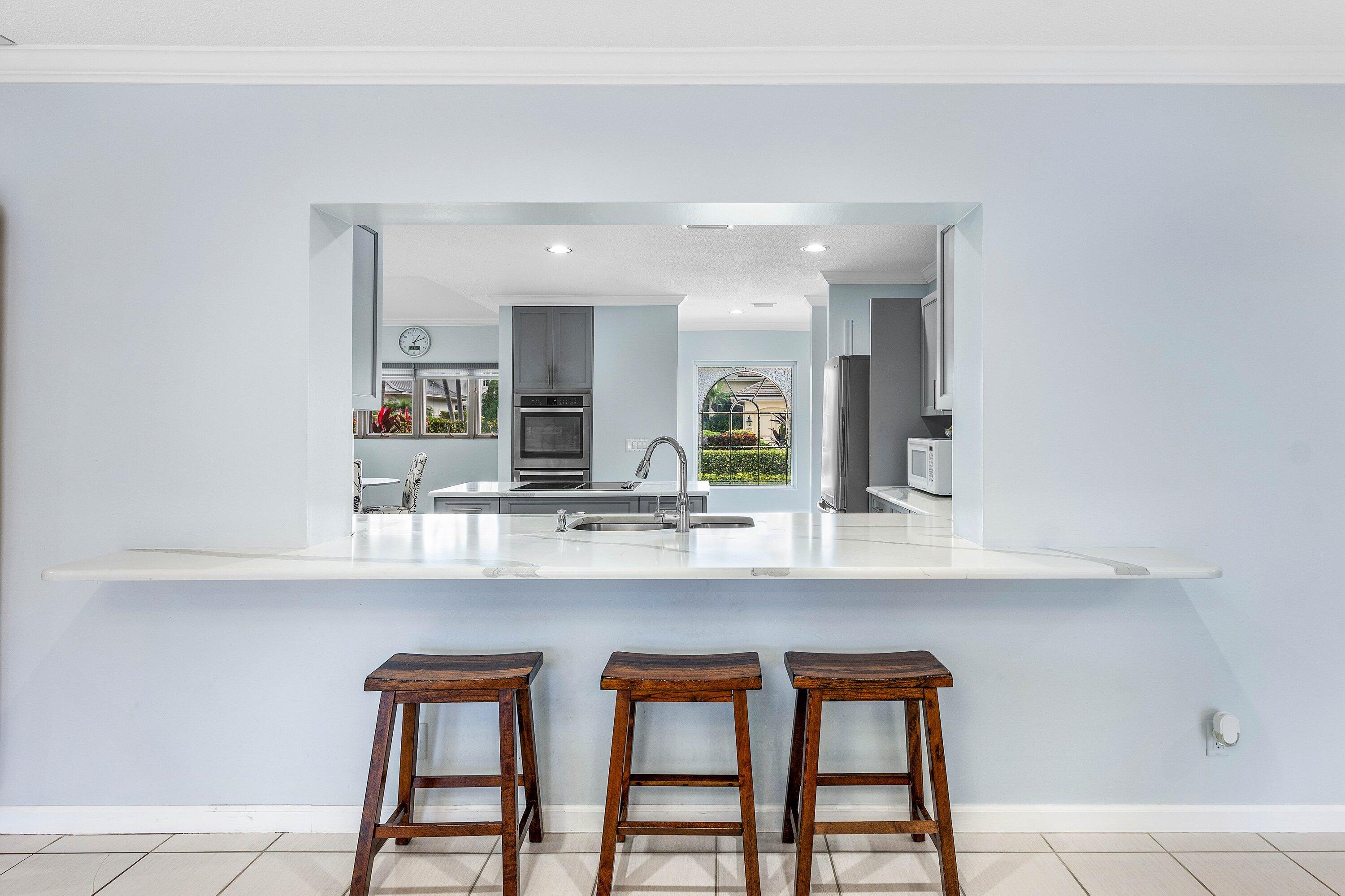2041 Thatch Palm Drive Boca Raton, FL 33432 - Photo 25 of 45 a kitchen with a table and chairs in it