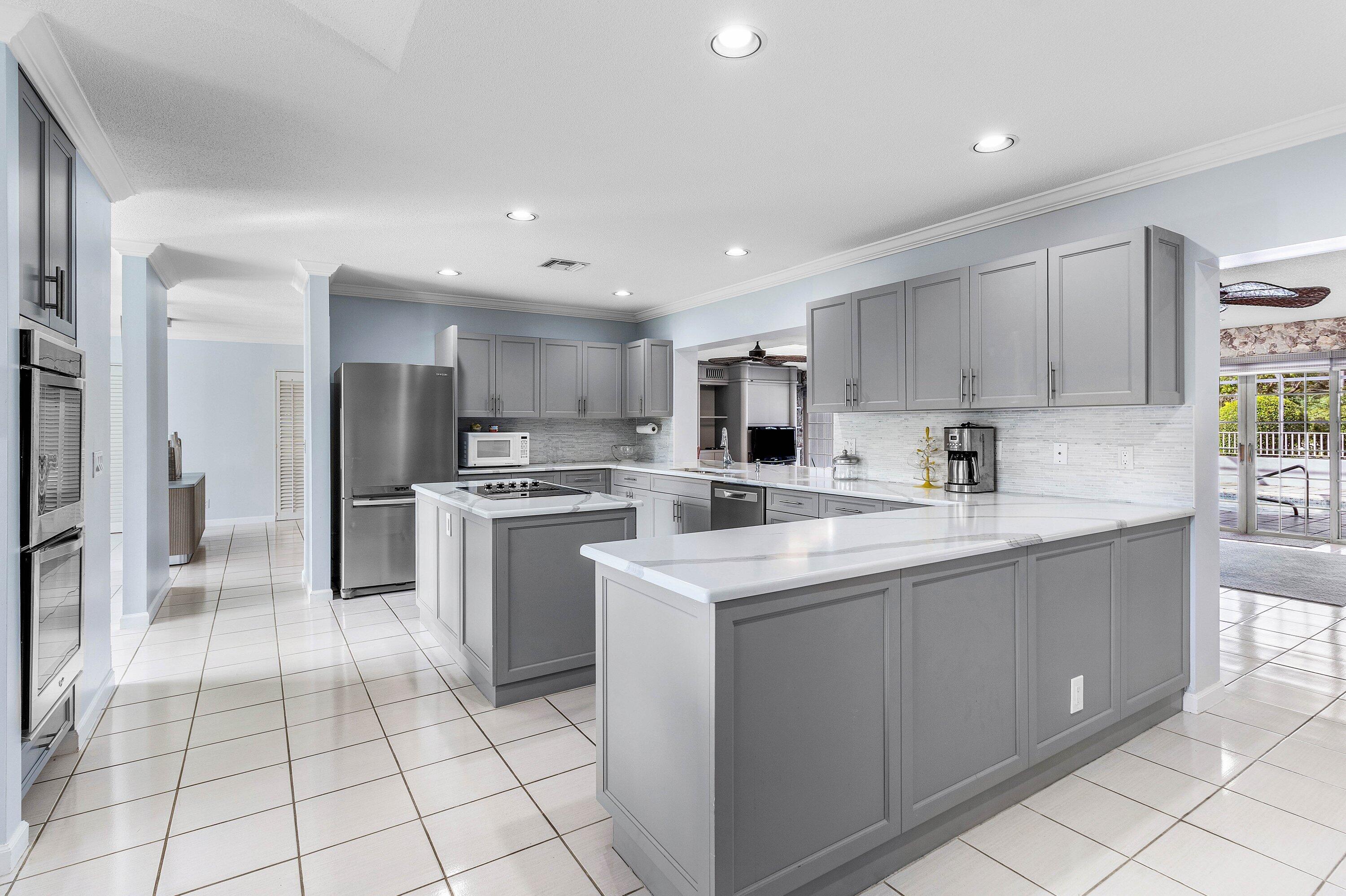 2041 Thatch Palm Drive Boca Raton, FL 33432 - Photo 27 of 45 a kitchen with white cabinets a sink and white appliances