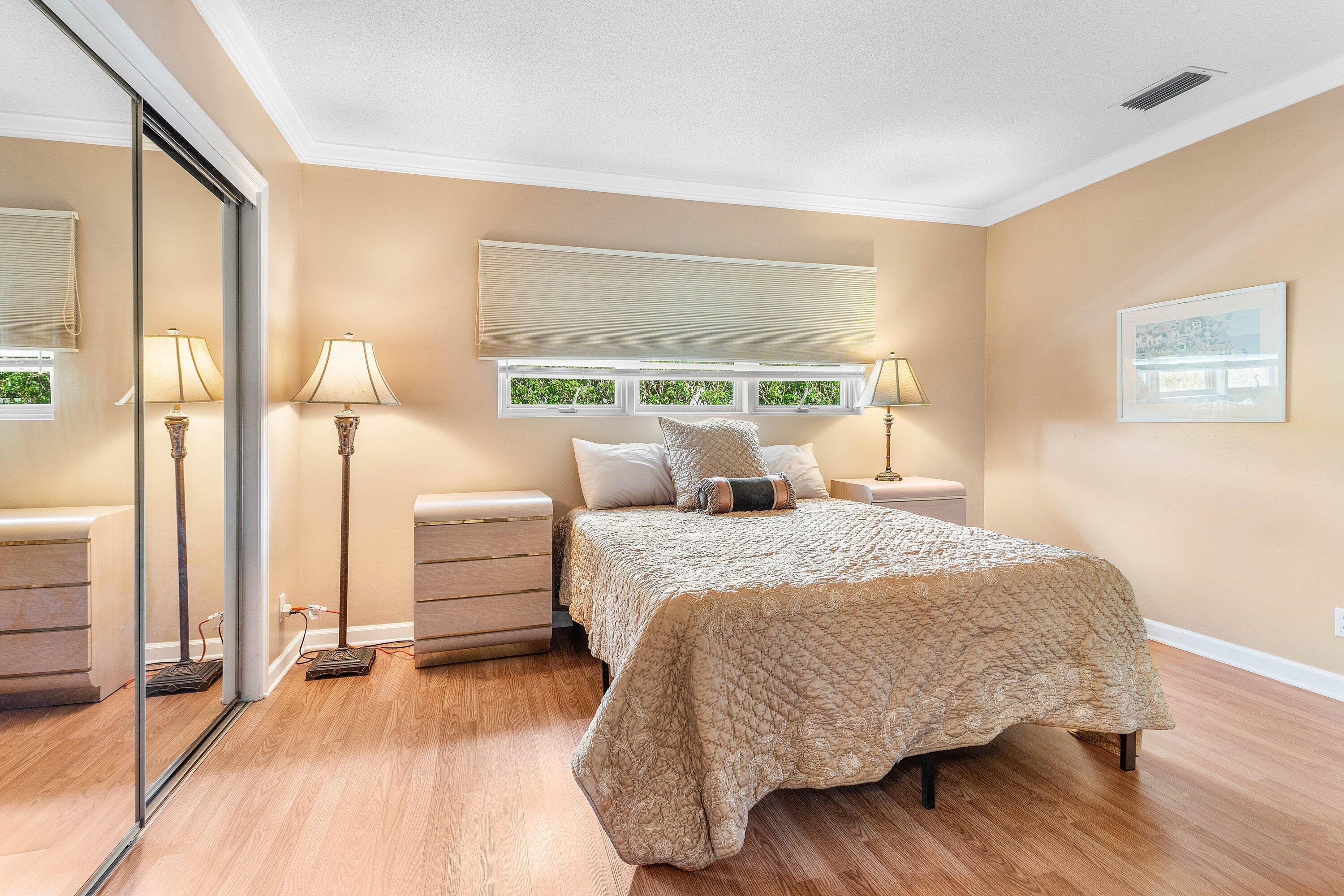 2041 Thatch Palm Drive Boca Raton, FL 33432 - Photo 33 of 45 a bedroom with a bed and wooden floor