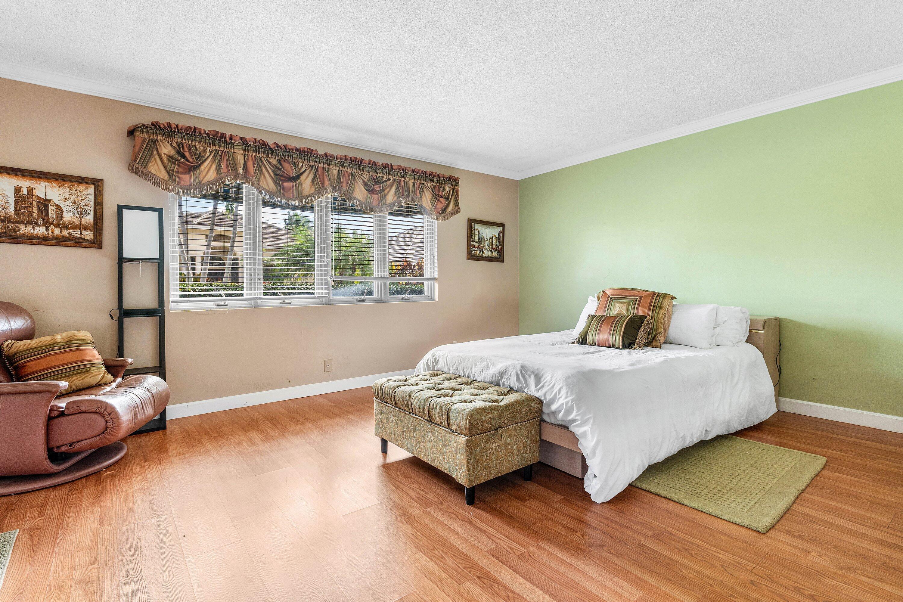 2041 Thatch Palm Drive Boca Raton, FL 33432 - Photo 34 of 45 a bedroom with a bed and wooden floor