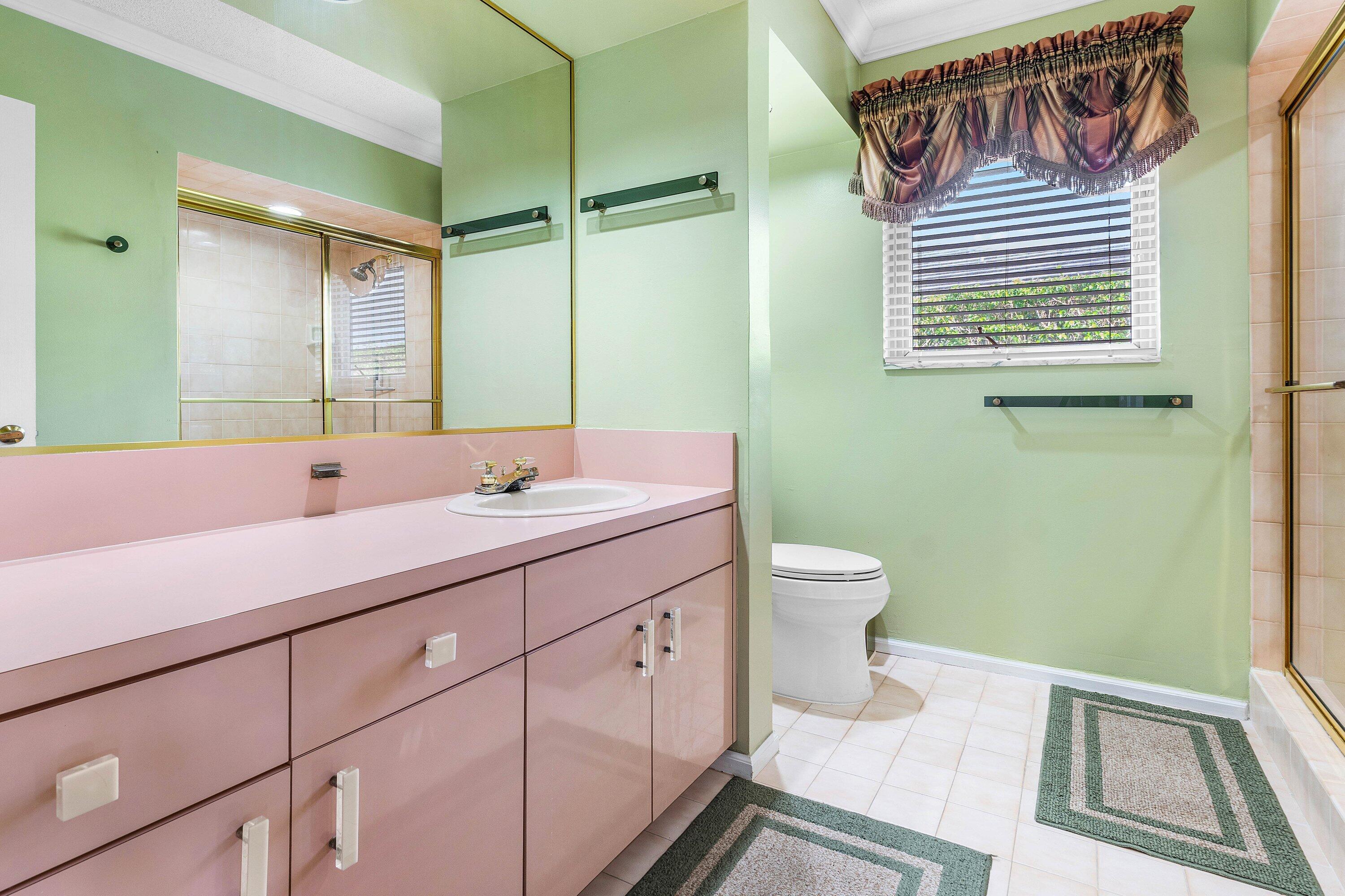 2041 Thatch Palm Drive Boca Raton, FL 33432 - Photo 35 of 45 a bathroom with a sink a toilet and a mirror