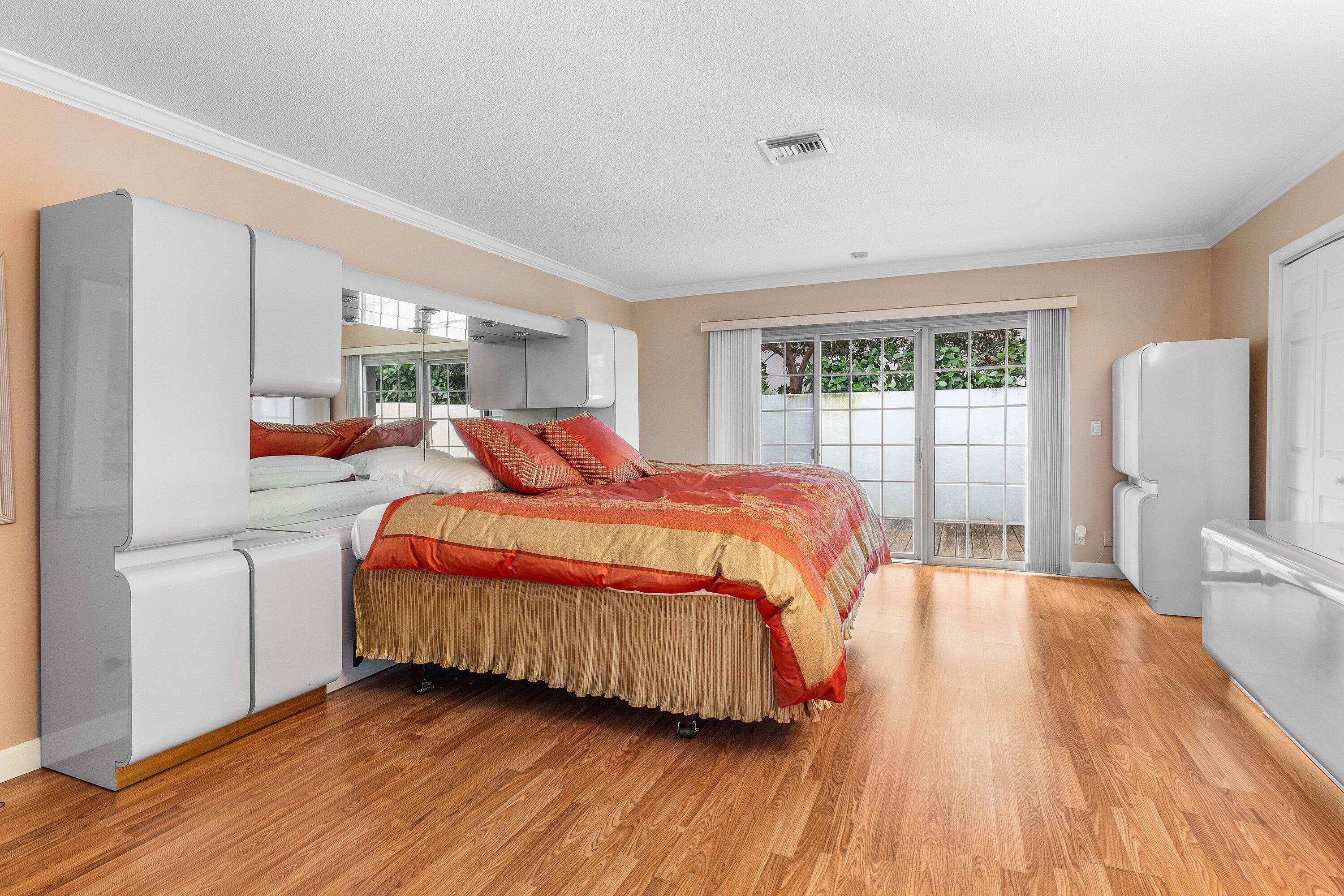 2041 Thatch Palm Drive Boca Raton, FL 33432 - Photo 37 of 45 a bedroom with a bed and wooden floor