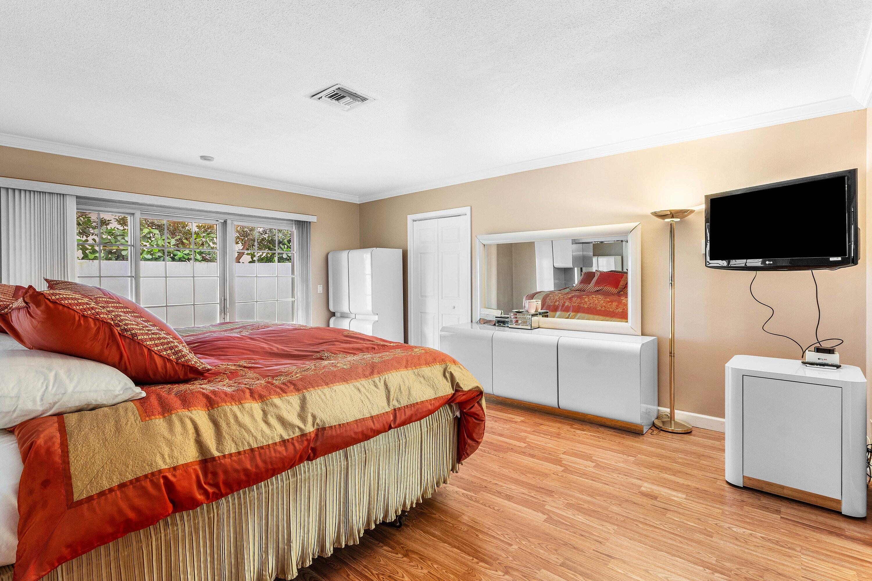 2041 Thatch Palm Drive Boca Raton, FL 33432 - Photo 38 of 45 a bedroom with a bed and a flat screen tv