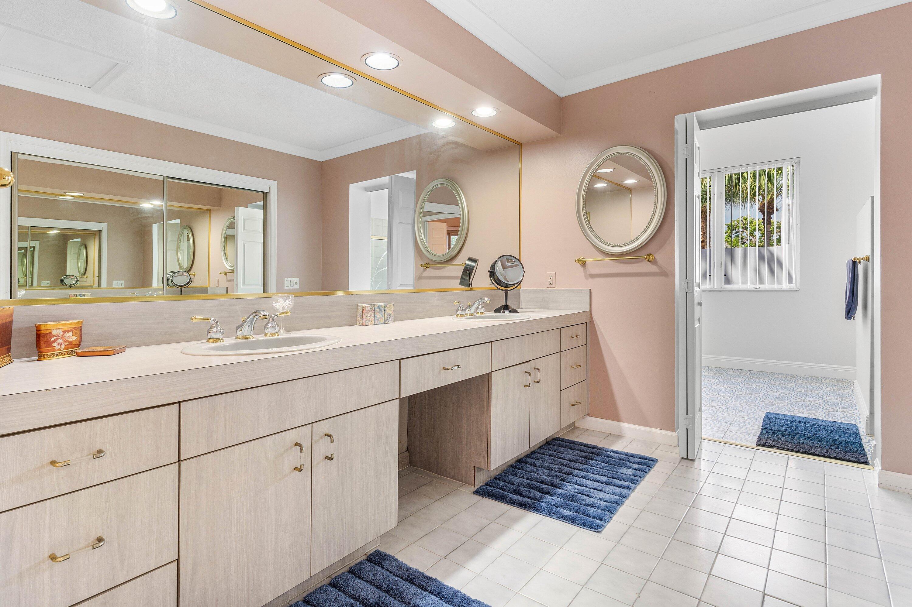 2041 Thatch Palm Drive Boca Raton, FL 33432 - Photo 39 of 45 a spacious bathroom with a double vanity sink and a mirror