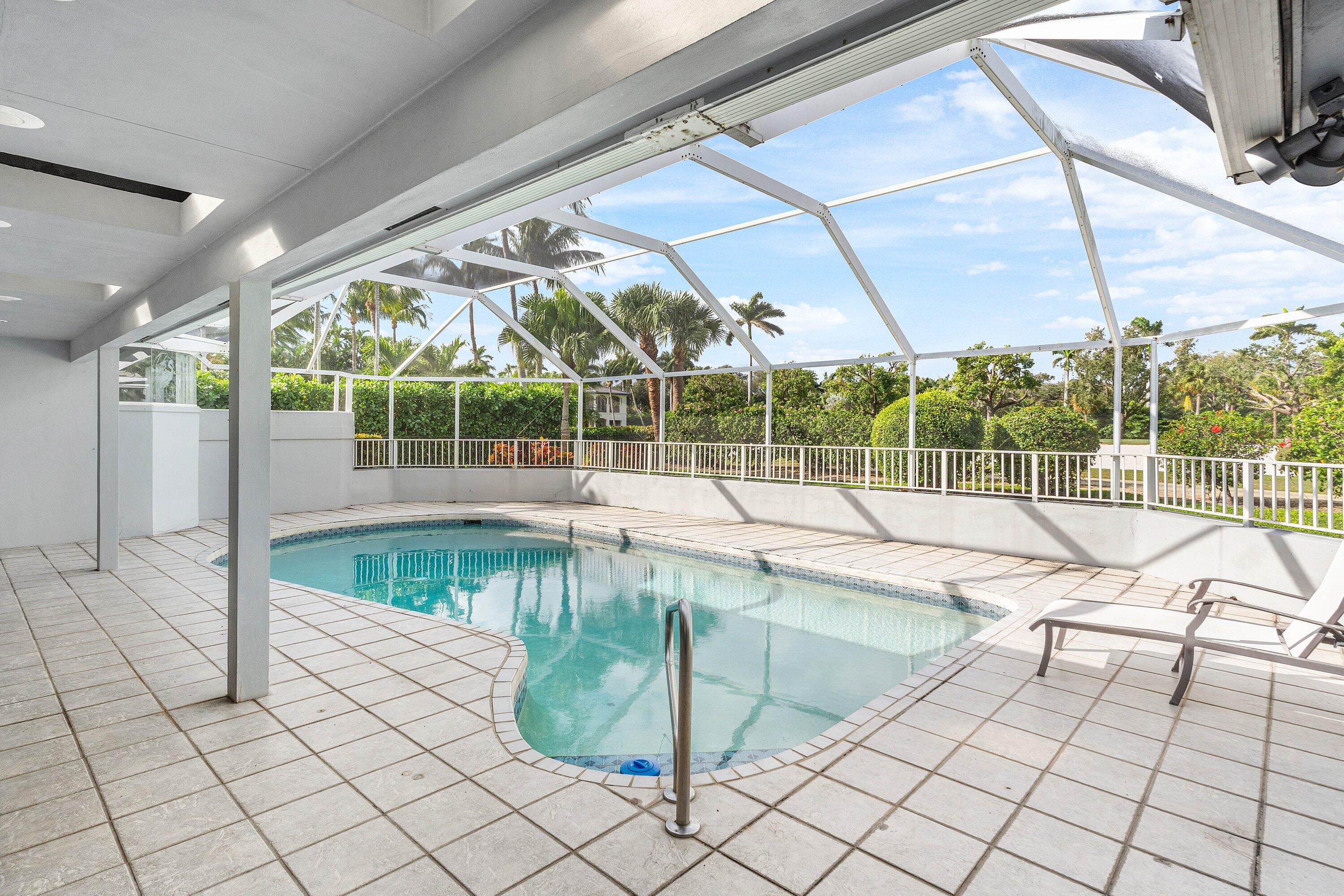 2041 Thatch Palm Drive Boca Raton, FL 33432 - Photo 41 of 45 a view of a swimming pool with a lounge chairs