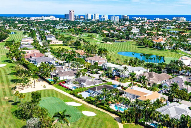 a view of a house with a yard and potted plants