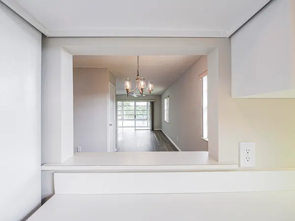 a view of staircase with kitchen island and chandelier