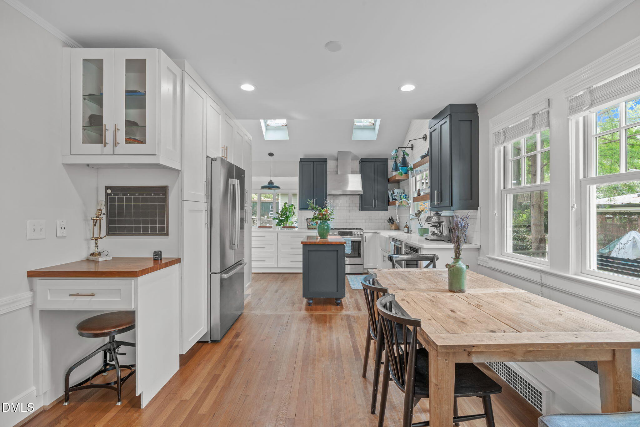 2111 Pershing Street Durham, NC 27705 - Photo 16 of 59 a kitchen with stainless steel appliances granite countertop a stove a refrigerator a kitchen island a dining table and chairs